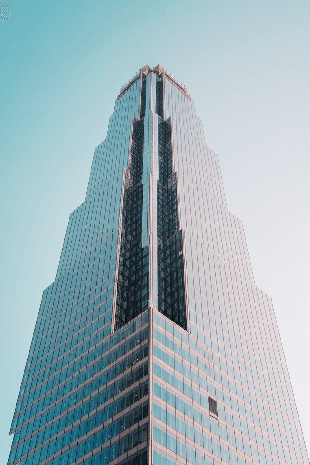 Glass office tower against a blue sky